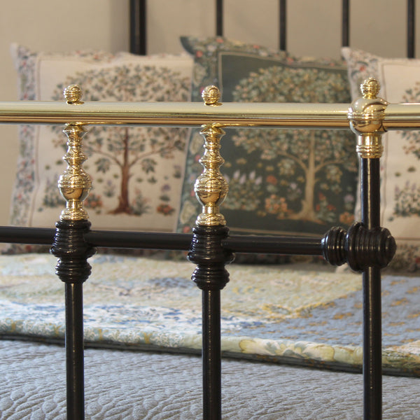 Close-up of a bed with decorative headboard and pillows