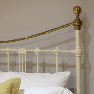 Close-up of a bed with a decorative headboard featuring gold and white elements.