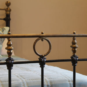 Close-up of an ornate metal bed frame with decorative elements.